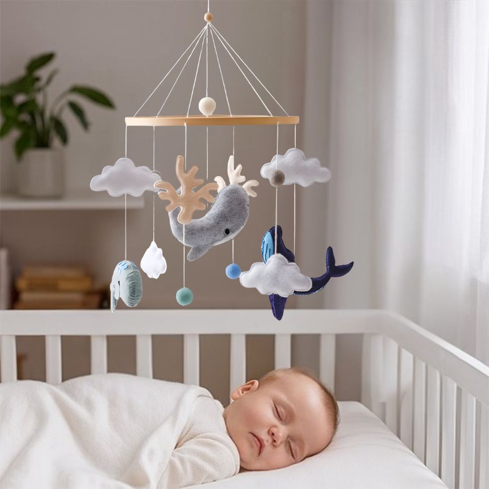 mobile bebe dauphin bleu gris bebe endormi dans berceau