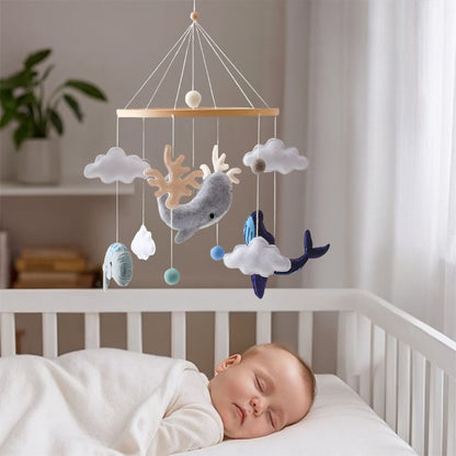 mobile bebe dauphin bleu gris bebe endormi dans berceau